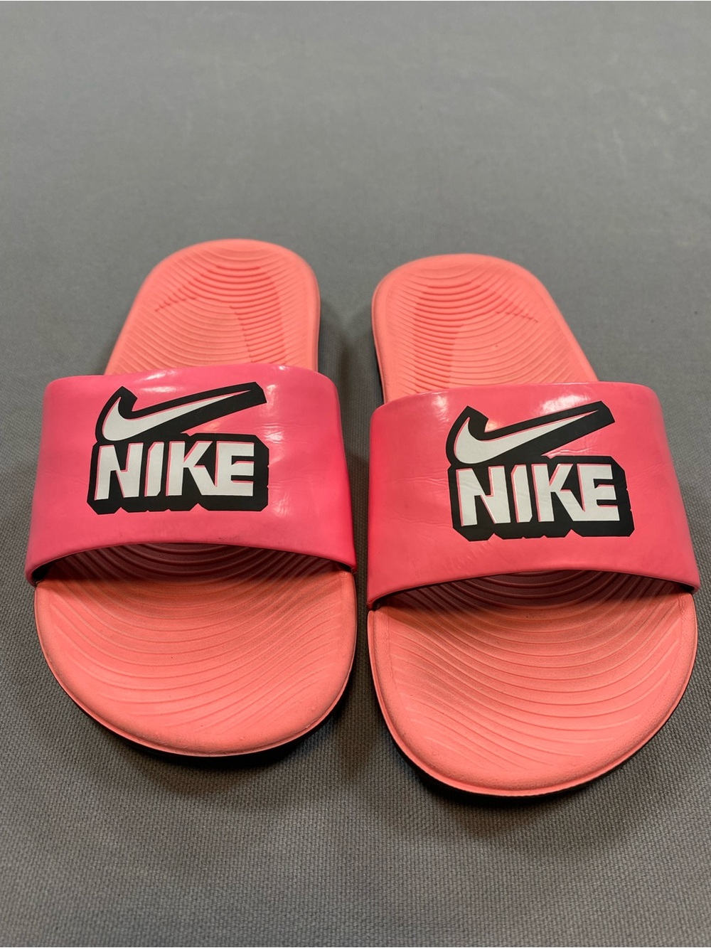 Nike pink slides Size 12c white swoosh with black outline.
